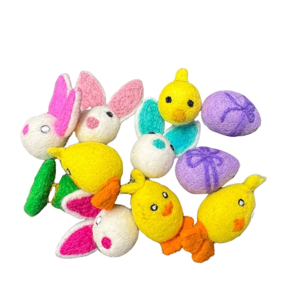 Colorful plush toys including bunnies, ducks, and eggs on a white background