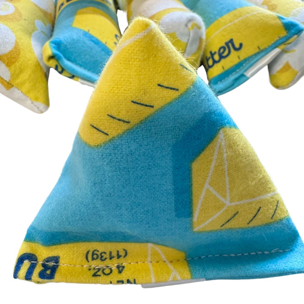 Close-up of butter print fabric on handmade cat toy with reinforced stitching