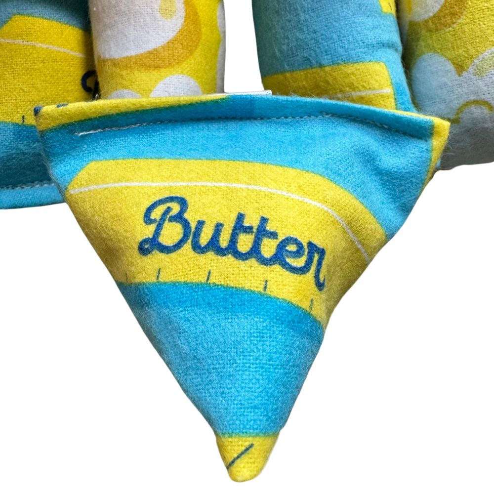 Detailed view of stitching on butter themed interactive cat toy