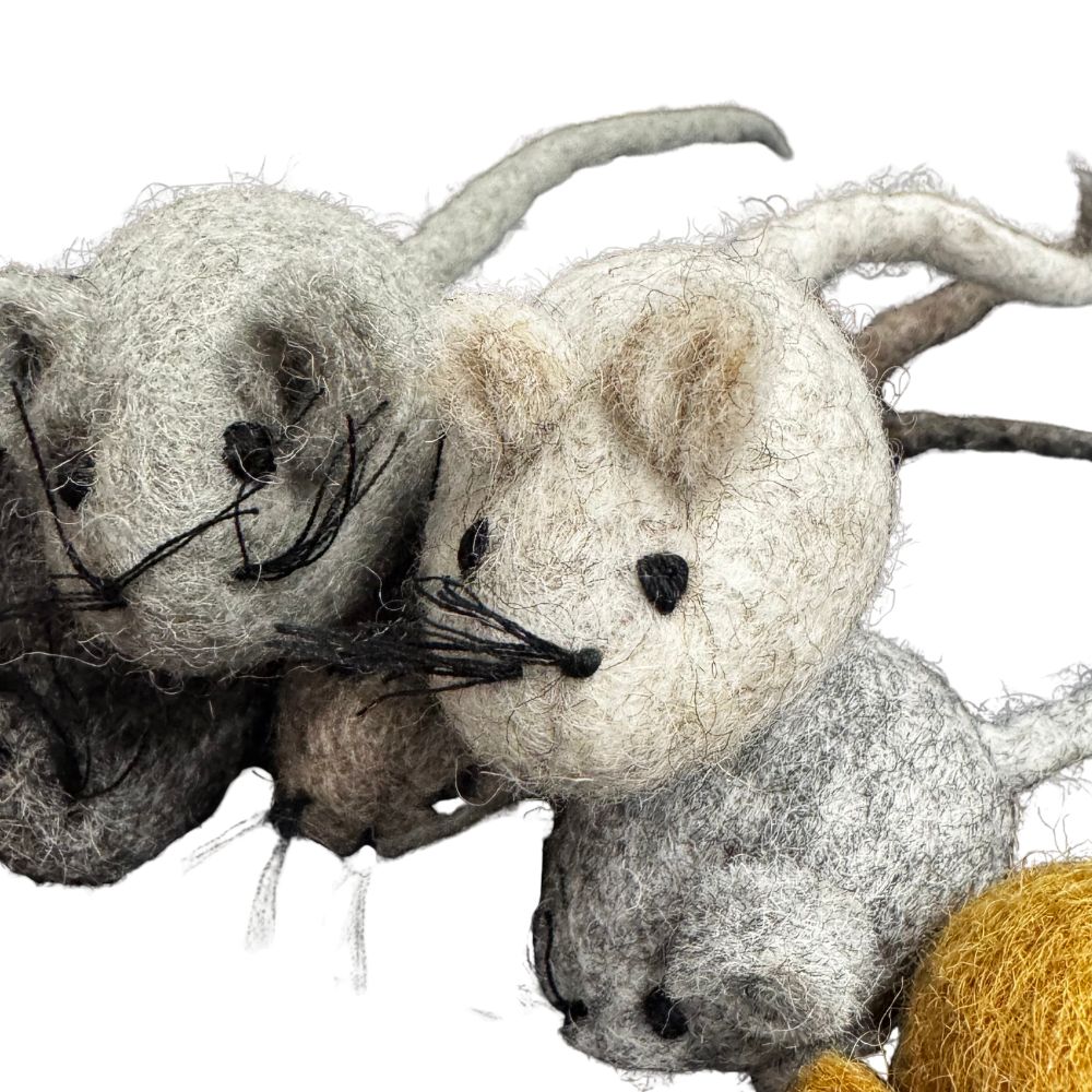 Three felted mouse toys in various colors on a white background
