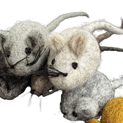 Three felted mouse toys in various colors on a white background