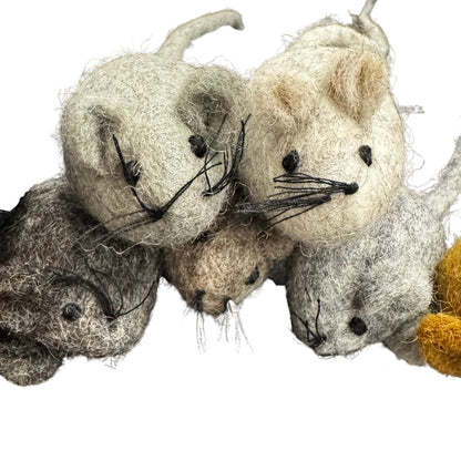 Three felted mouse toys in different colors on a white background