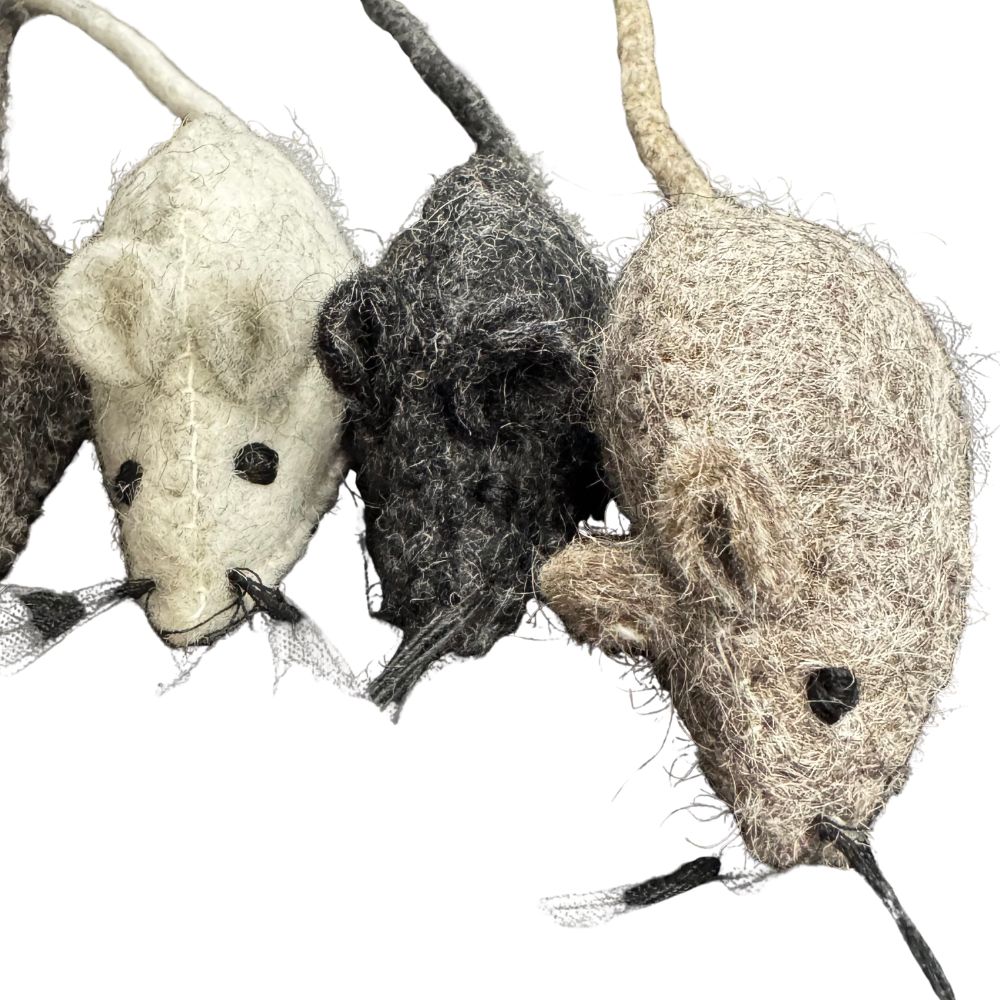 Three woolen mouse toys in different colors on a white background