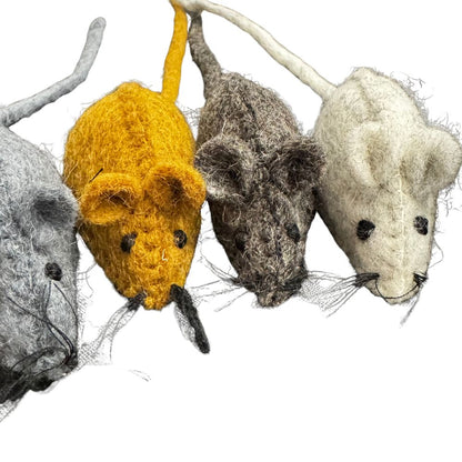 Four woolen mouse toys in different colors on a white background