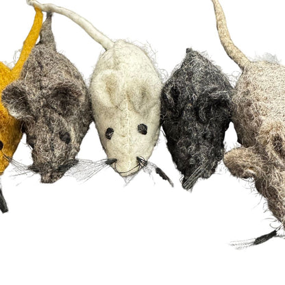 Four woolen mice in different colors on a white background
