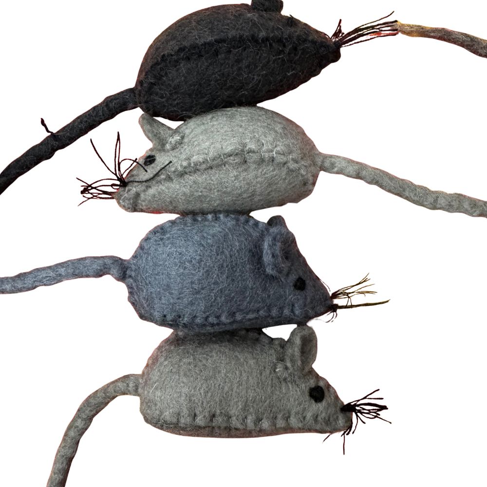 Three gray felted mouse toys stacked on a branch against a white background