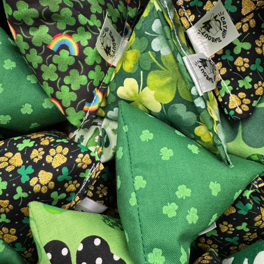 A collection of St. Patrick’s Day-themed Happy Sack catnip toys featuring shamrocks, pots of gold, rainbows, and leprechaun-inspired designs for playful cats made by CatnipTakeout