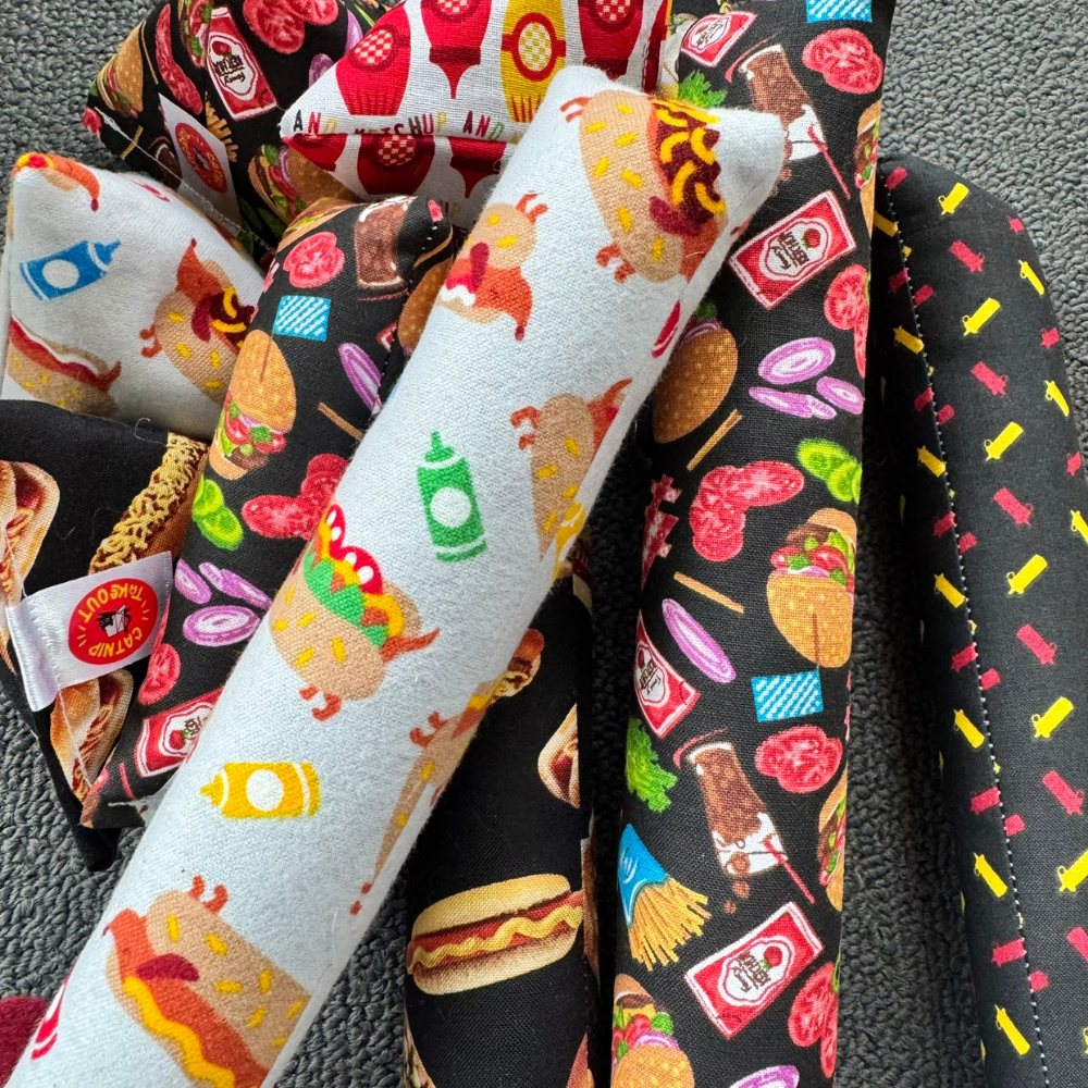 Catnip toys with burgers, hot dogs, ketchup bottles, mustard bottles, pickles, fries, and grilling inspired foodie themes