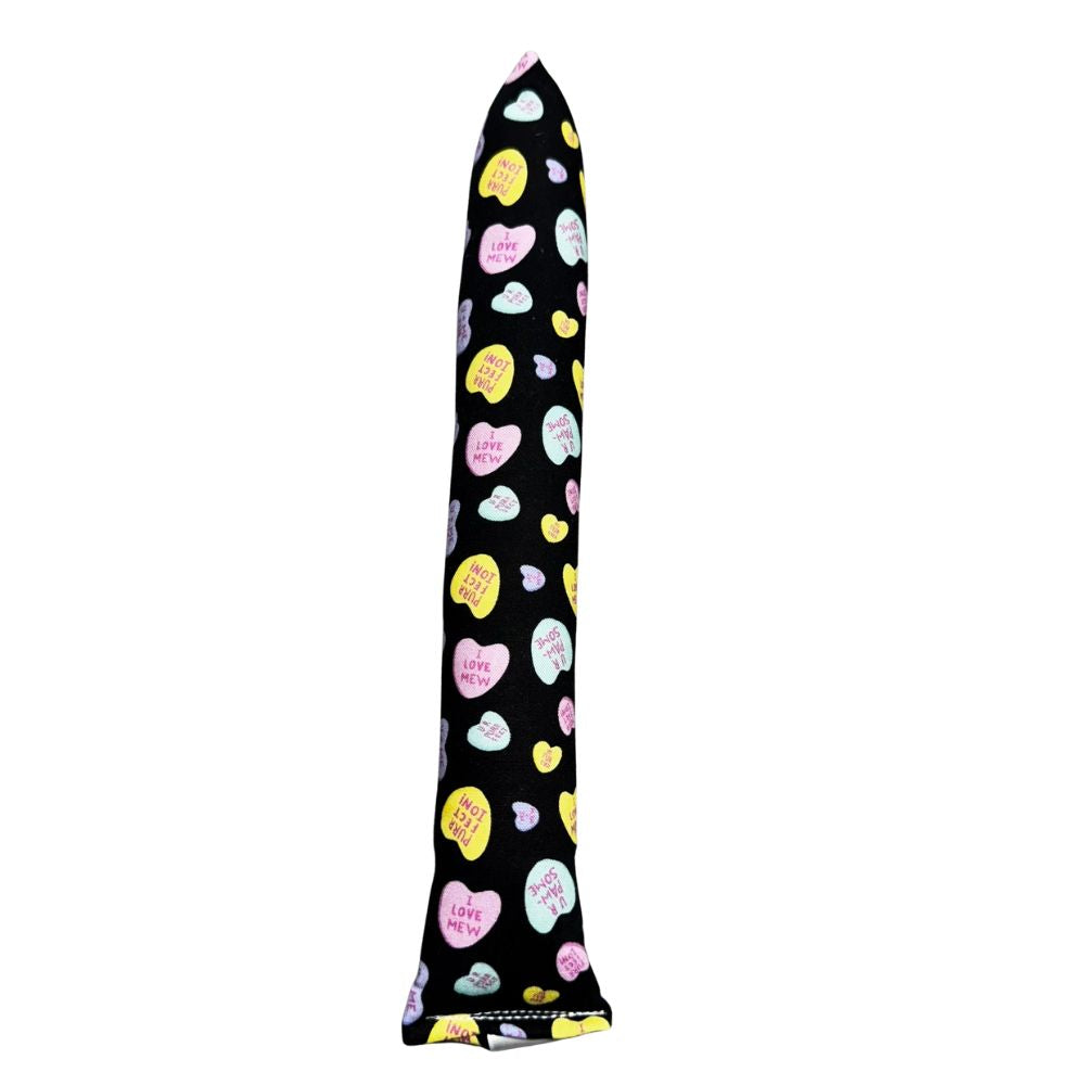 Handmade full-size kicker cat toy in black fabric with pastel candy hearts, long shape for bunny-kicking and wrestling, filled with signature premium catnip. Made by CatnipTakeout.