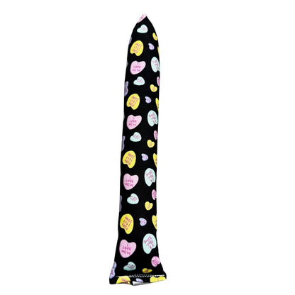 Handmade full-size kicker cat toy in black fabric with pastel candy hearts, long shape for bunny-kicking and wrestling, filled with signature premium catnip. Made by CatnipTakeout.