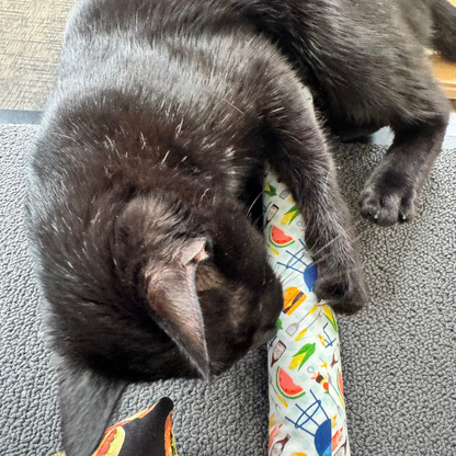 Black cat bunny kicking grilling inspired kicker cat toy with burgers, corn, skewers, watermelon, and picnic foods