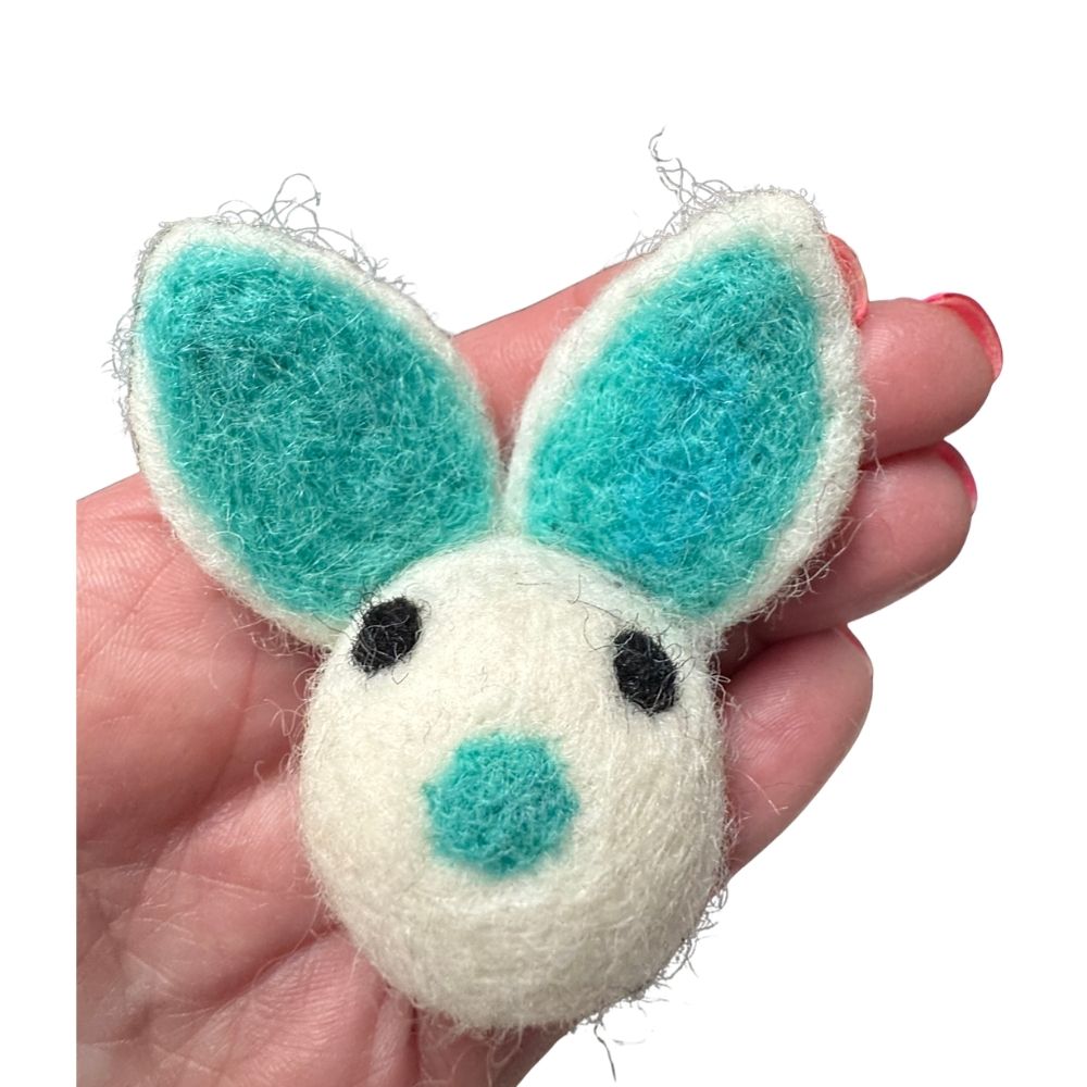 Bunny cat toy shown in hand for size reference sprayed with catnip