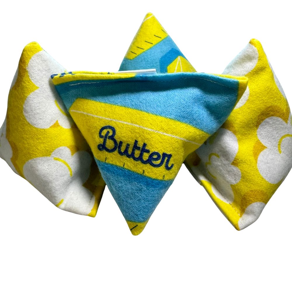 Front view of butter themed cat toy designed for self-play and batting