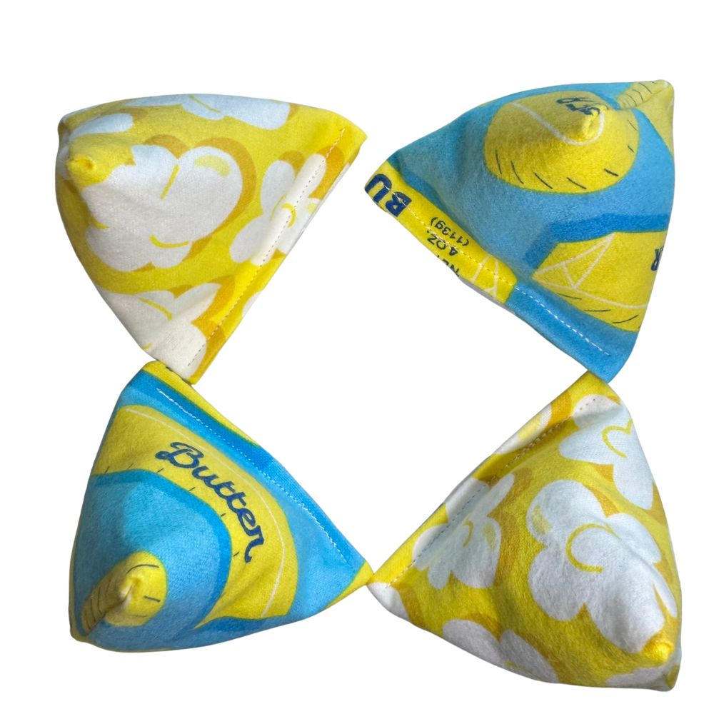 Four-angle collage of butter print pyramid cat toy showing shape, seams, and fabric details