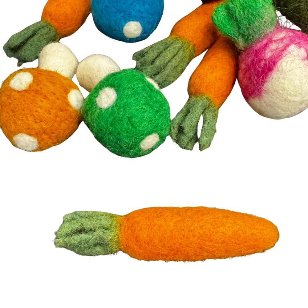 set-detail.jpg
Image showing a single carrot-shaped cat toy below and a partial view above of mixed veggie cat toys, including mushrooms and radishes. Bright orange felted carrot with textured green leafy top
