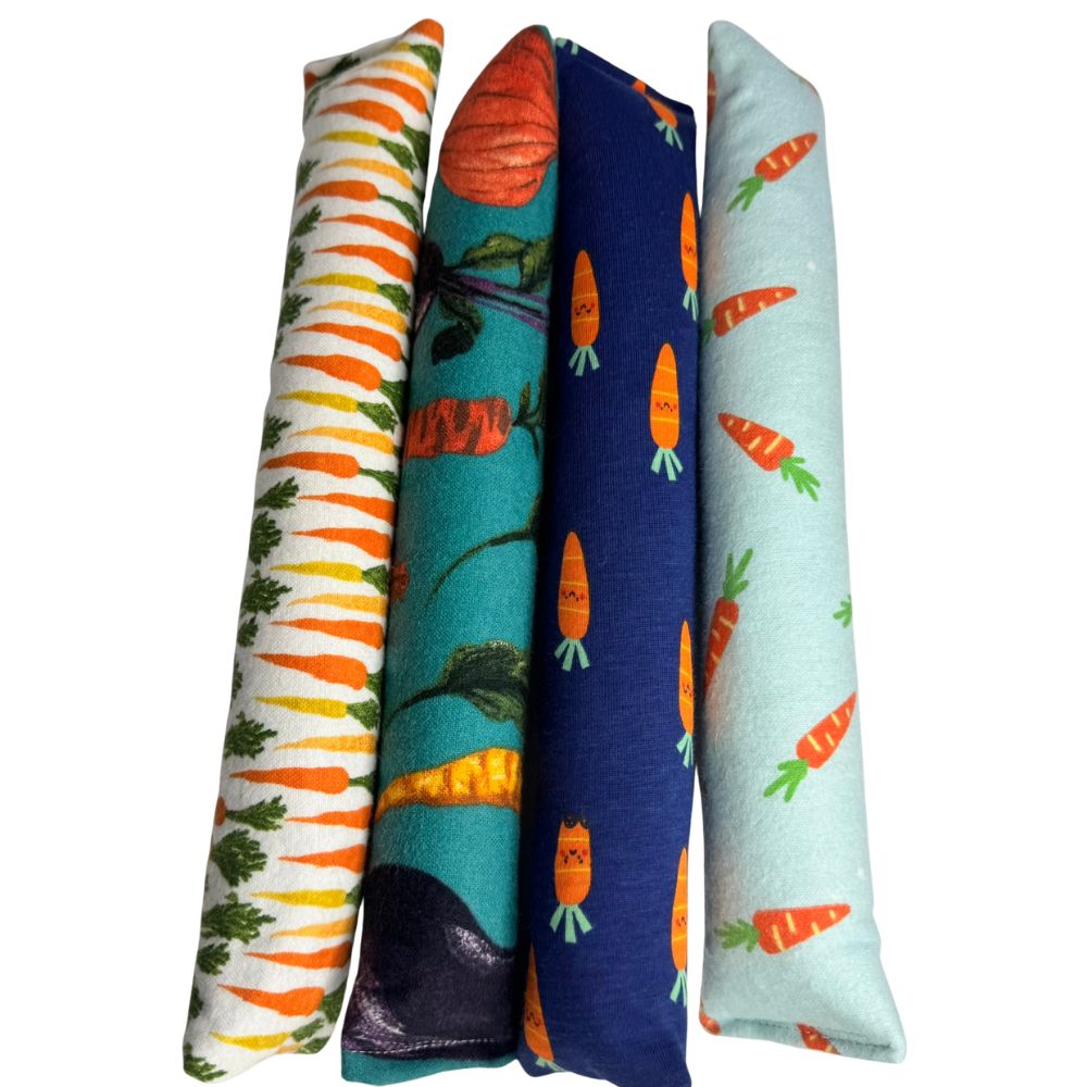 Four carrot cat toy Kickers lined up together for grabbing, wrestling, and bunny kick play