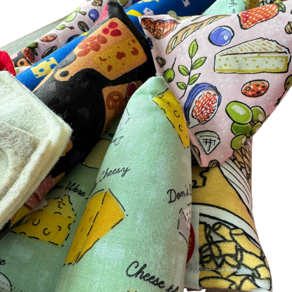 Cheese themed catnip toys from CatnipTakeout featuring foodie inspired designs for batting, chasing, and interactive cat play