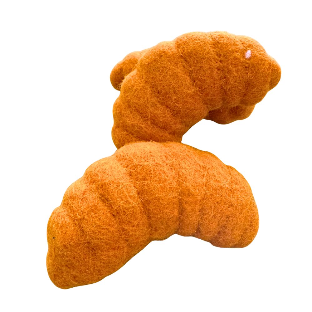 Two croissant-shaped cat toys stacked together on a white background, showing curved pastry forms and textured felt surfaces for independent cat play