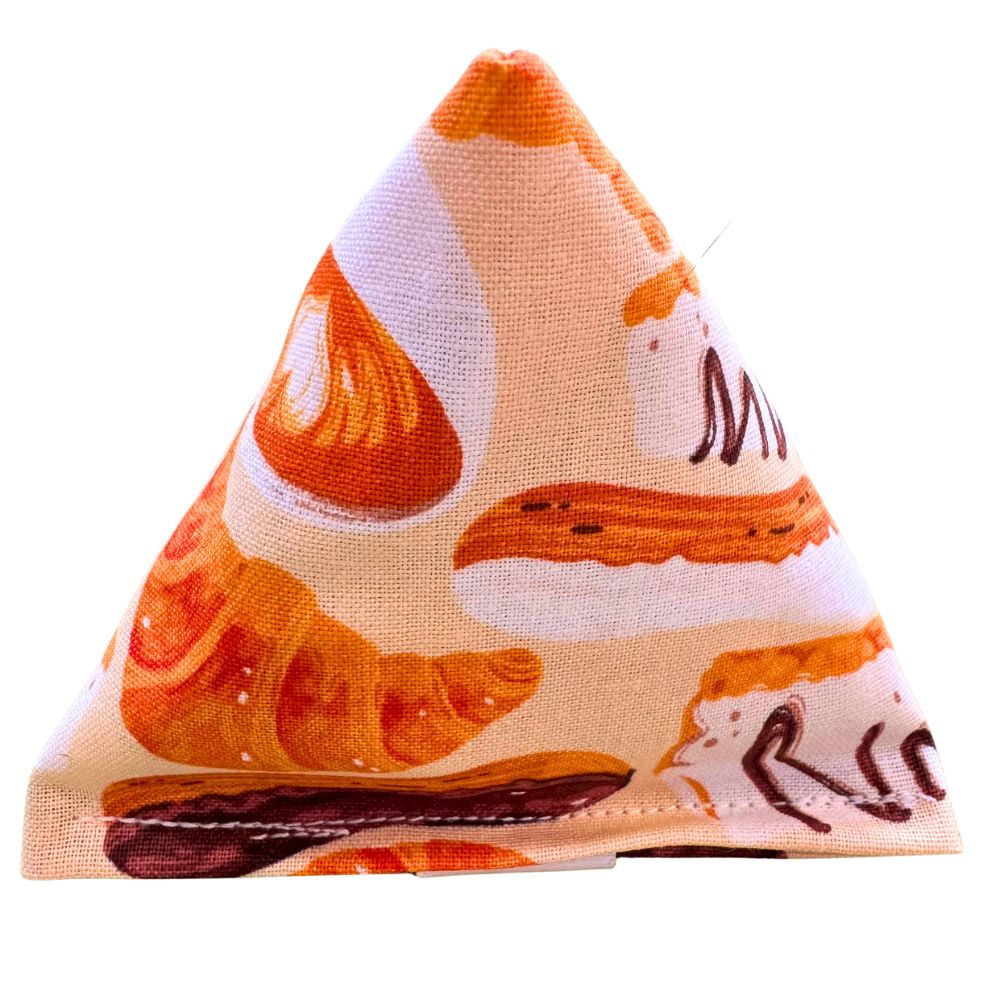 CatnipTakeout Croissant Happy Sack cat toy shown in a pyramid form using a pink bakery fabric with repeating croissant motifs and dessert details, designed for interactive kitten play, paw grabbing, and catnip-driven zoomies