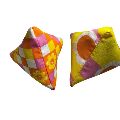 Close-up of Happy Sack Cat Toys in retro floral prints, showcasing bold gingham and daisy styles, stuffed with catnip. Made by CatnipTakeout.