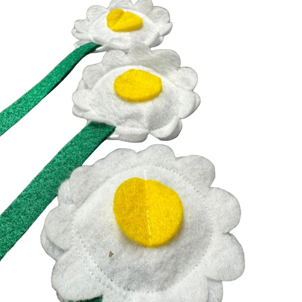 lose up of felt daisy cat toy filled with catnip showing layered petals and soft textured center.