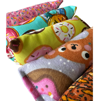 Close-up of donut cat toy Kickers in assorted donut assortments for grab-and-kick play sessions