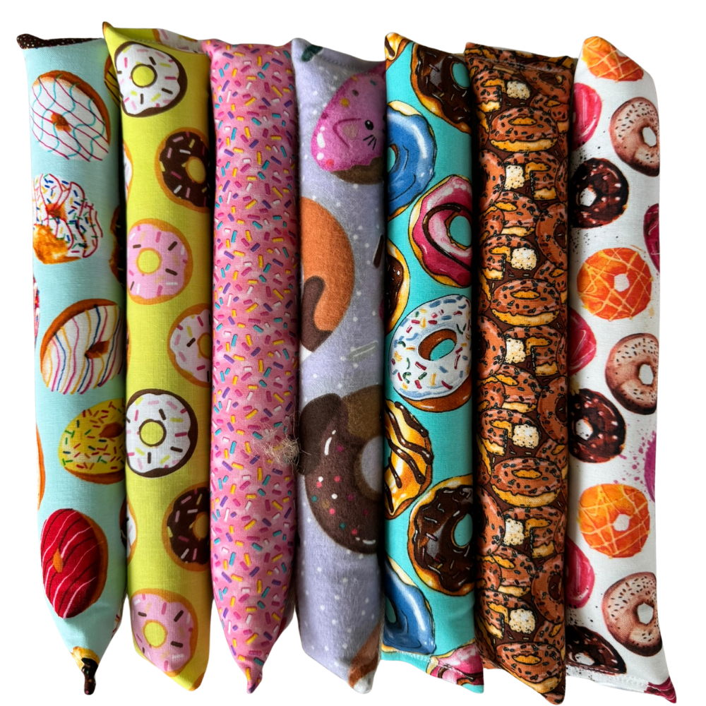 Donut cat toy Kickers lined up upright to show long shapes made for grabbing and bunny kicks