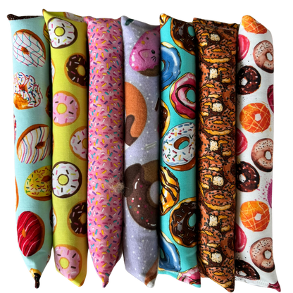 Donut cat toy Kickers lined up upright to show long shapes made for grabbing and bunny kicks