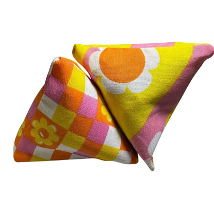 Two Spring Happy Sack Cat Toys in bright daisy prints with pink and yellow fabric, filled with aromatic catnip. Made by CatnipTakeout.
