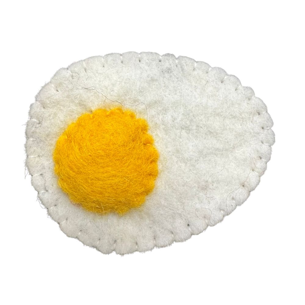 Handmade white and yellow wool sunny side up egg cat toy sprayed with premium catnip for indoor bunny kick play and enrichment.
