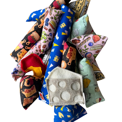Handmade cheese cat toys filled with catnip including kicker toys and Happy Sack cat toys for playful indoor cats