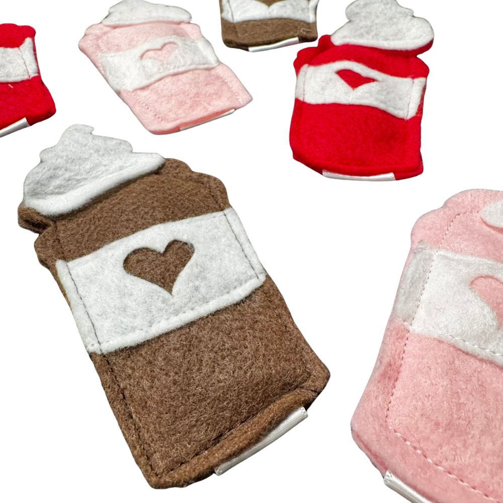 Close-up of handmade classic coffee brown felt latte cat toy with white sleeve and heart detail, filled with premium catnip. Made by CatnipTakeout