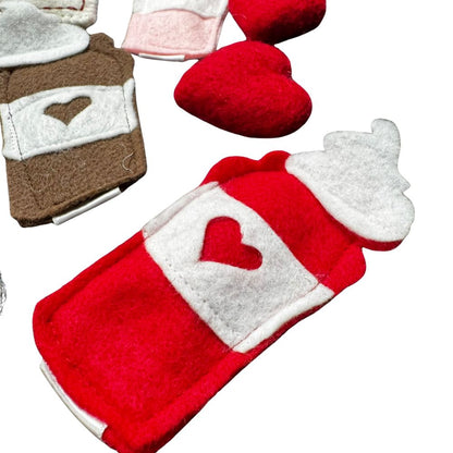 Close-up of handmade red felt latte cat toy with white whipped cream top and stitched heart detail, filled with premium catnip. Made by CatnipTakeout.