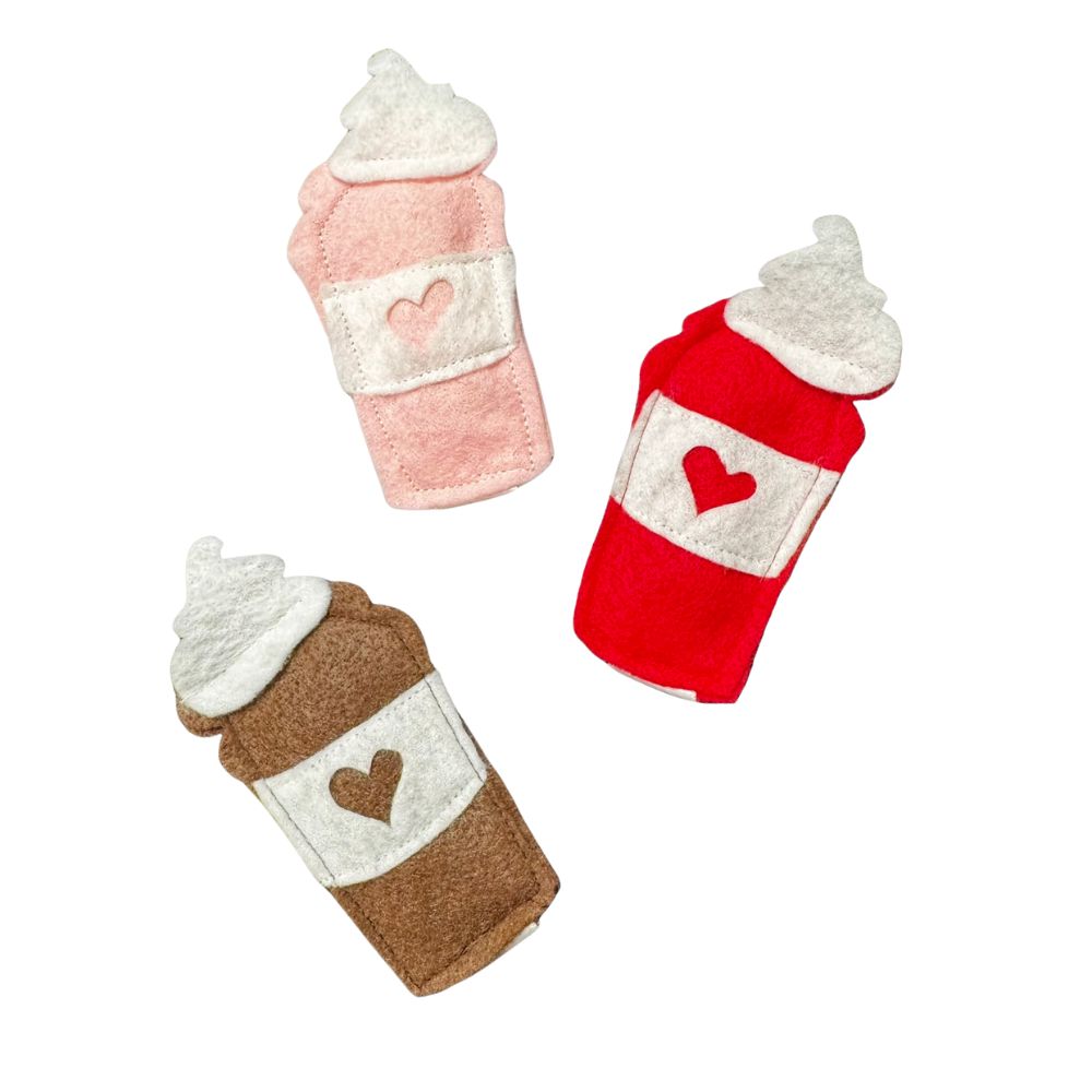 Group photo of three handmade felt latte cat toys in red, pink, and coffee brown, all filled with premium catnip. Made by CatnipTakeout.