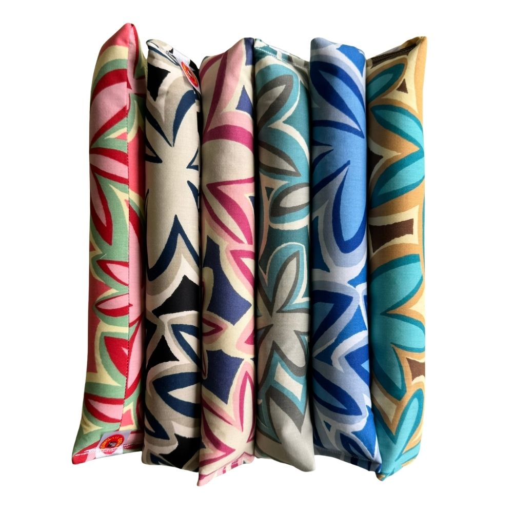 Maui Vibes kicker cat toy lineup in six retro plumeria prints, handmade with premium catnip for bored cats who love grabbing, kicking, and active play.