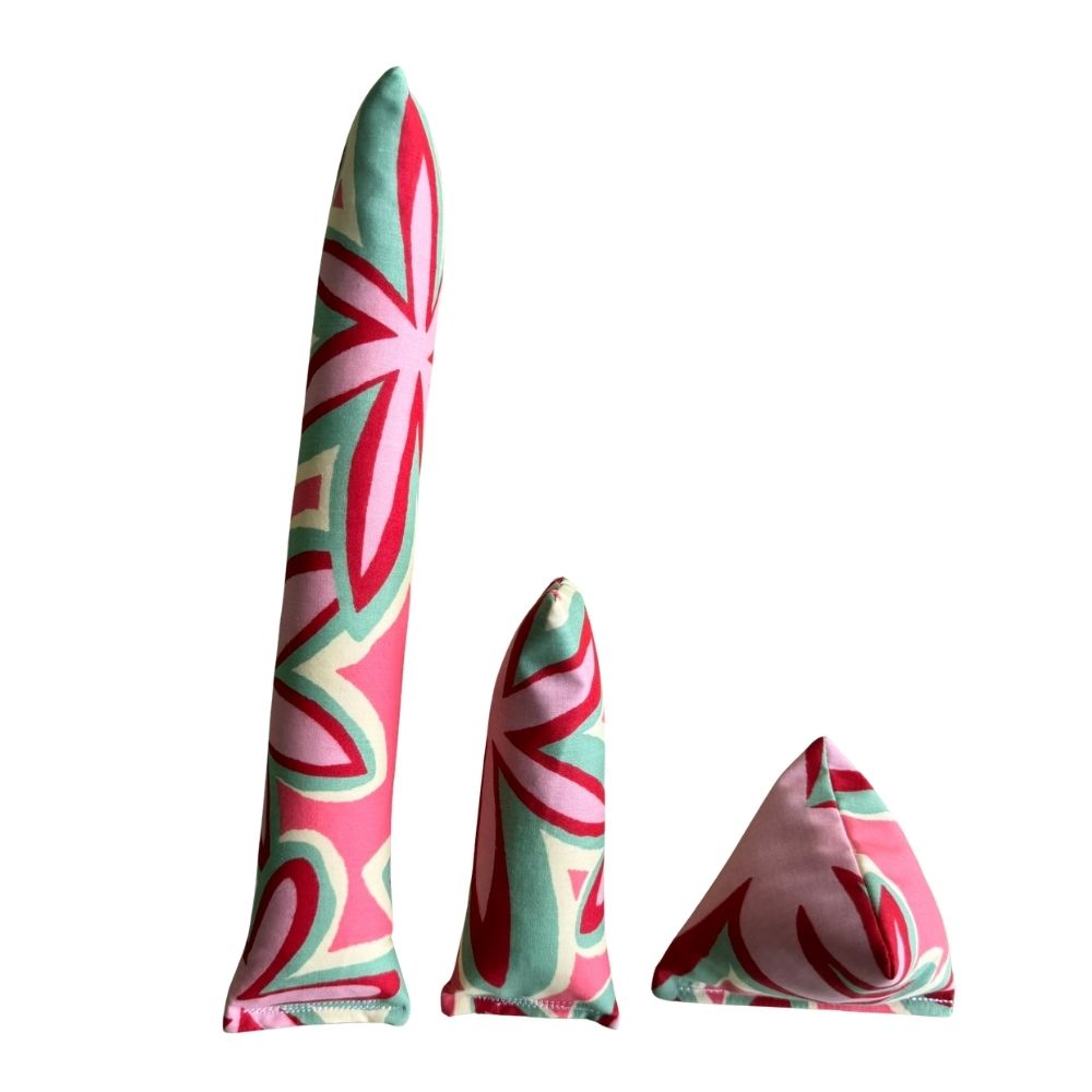 Maui Vibes Pink Hibiscus print cat toys shown as Kicker, Mini Kicker, and Happy Sack in pink, mint, and red retro plumeria fabric.