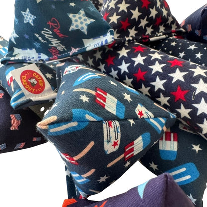 Close view of patriotic Happy Sack cat toy with popsicle print beside festive Mini Kickers and Kickers filled with premium catnip