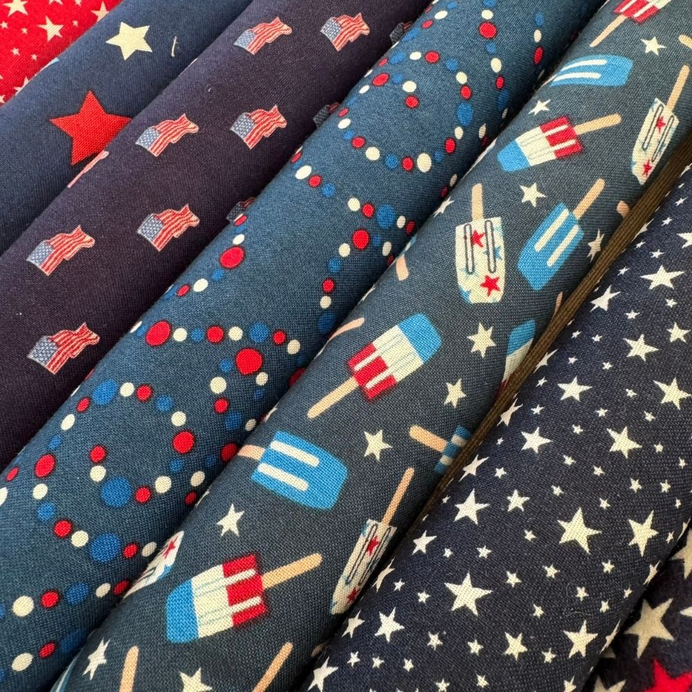 Close view of patriotic Kicker cat toys with fireworks, stars, popsicles, and flag inspired prints filled with premium catnip