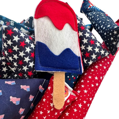 Handmade patriotic popsicle cat toy with red, white, and blue felt layers filled with premium catnip
