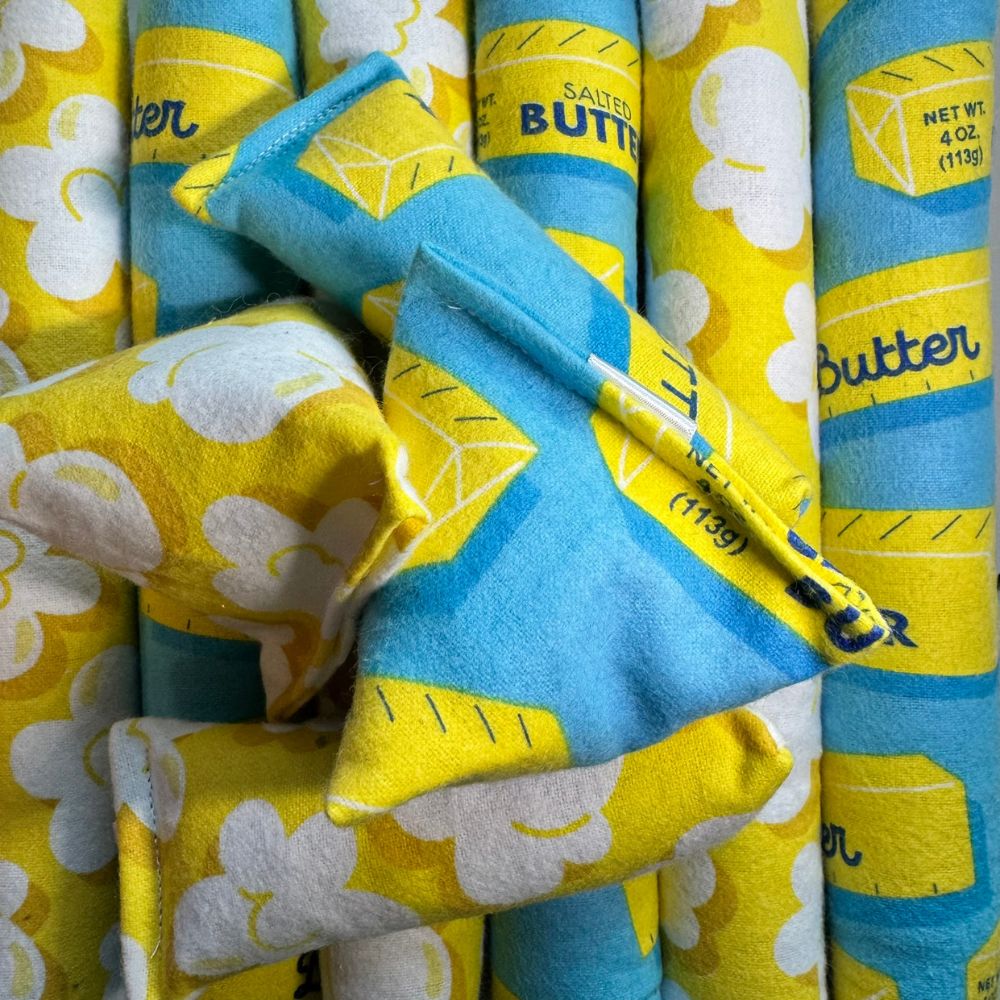Assorted catnip toys including happy sacks, kickers, and mini kickers showing both popcorn print and butter print fabrics together