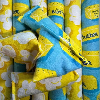 Assorted catnip toys including happy sacks, kickers, and mini kickers showing both popcorn print and butter print fabrics together