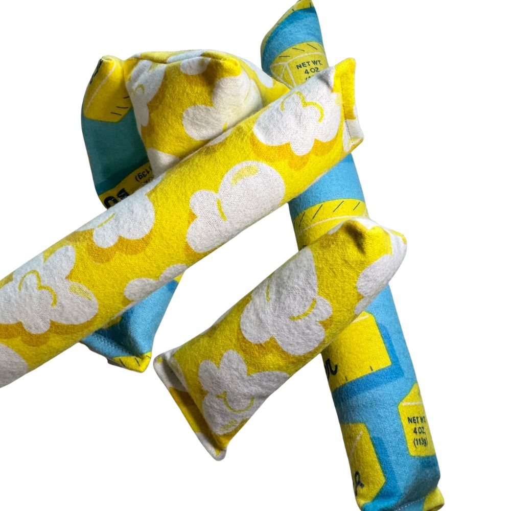 Assorted catnip kicker and mini kicker cat toys showing both popcorn print and butter print fabrics together