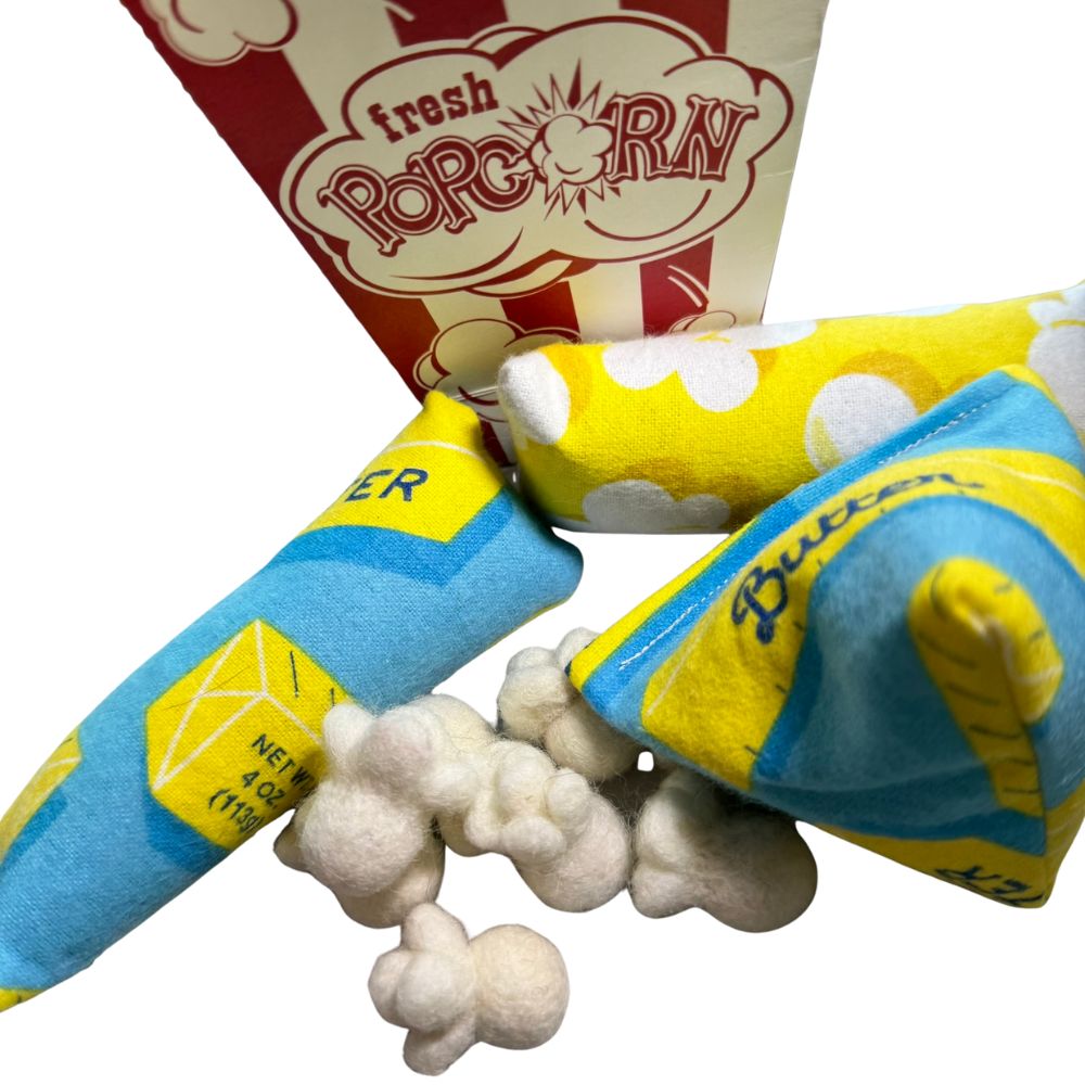 Popcorn-themed cat toys sprayed with catnip shown at an angled close view, interactive toys designed for batting, kicking, and independent play by CatnipTakeout