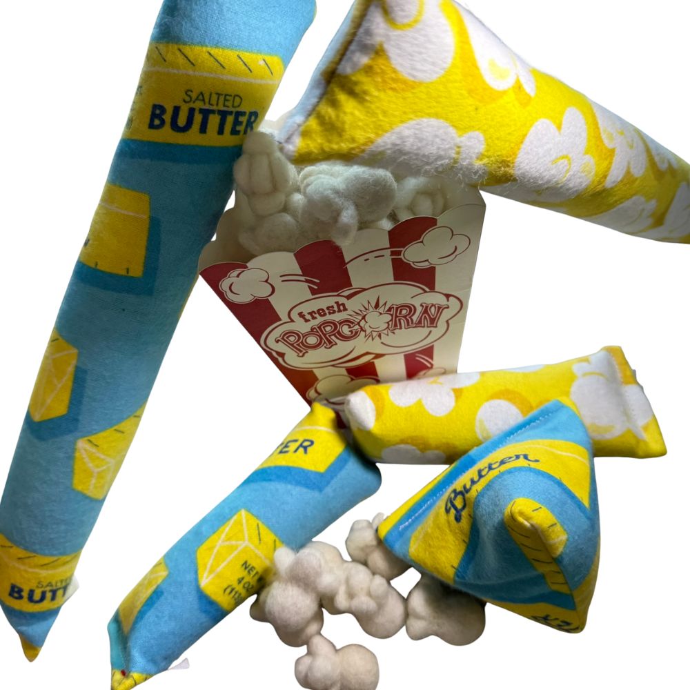 Popcorn-themed cat toys sprayed  and filled with catnip, shown with mini kickers and popcorn pieces, handmade and durable toys designed for interactive kicking, batting, and indoor cat play by CatnipTakeout
