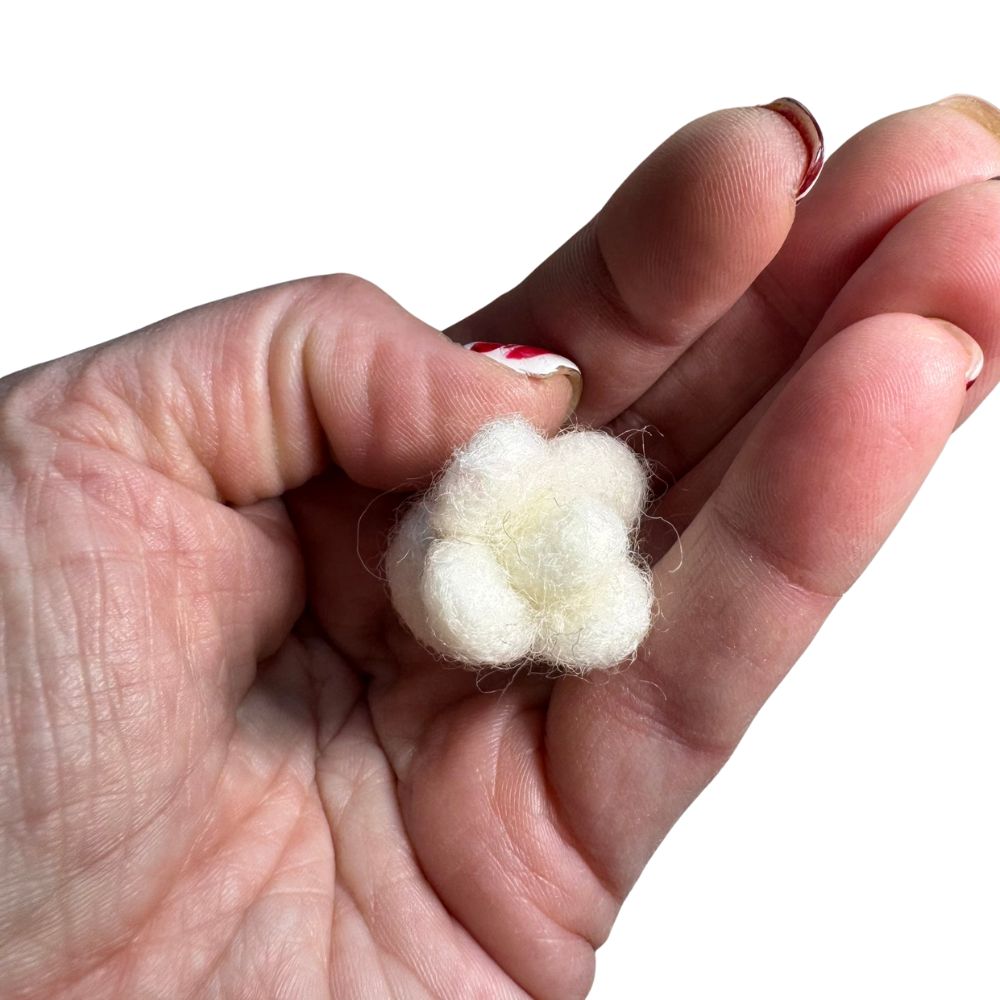Small popcorn-shaped cat toy sprayed with catnip shown in hand for scale, lightweight toy designed for batting and independent play by CatnipTakeout