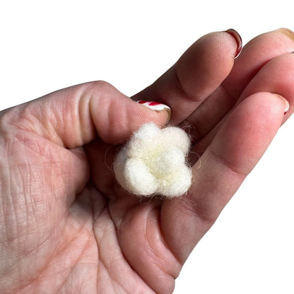 Small popcorn-shaped cat toy sprayed with catnip shown in hand for scale, lightweight toy designed for batting and independent play by CatnipTakeout