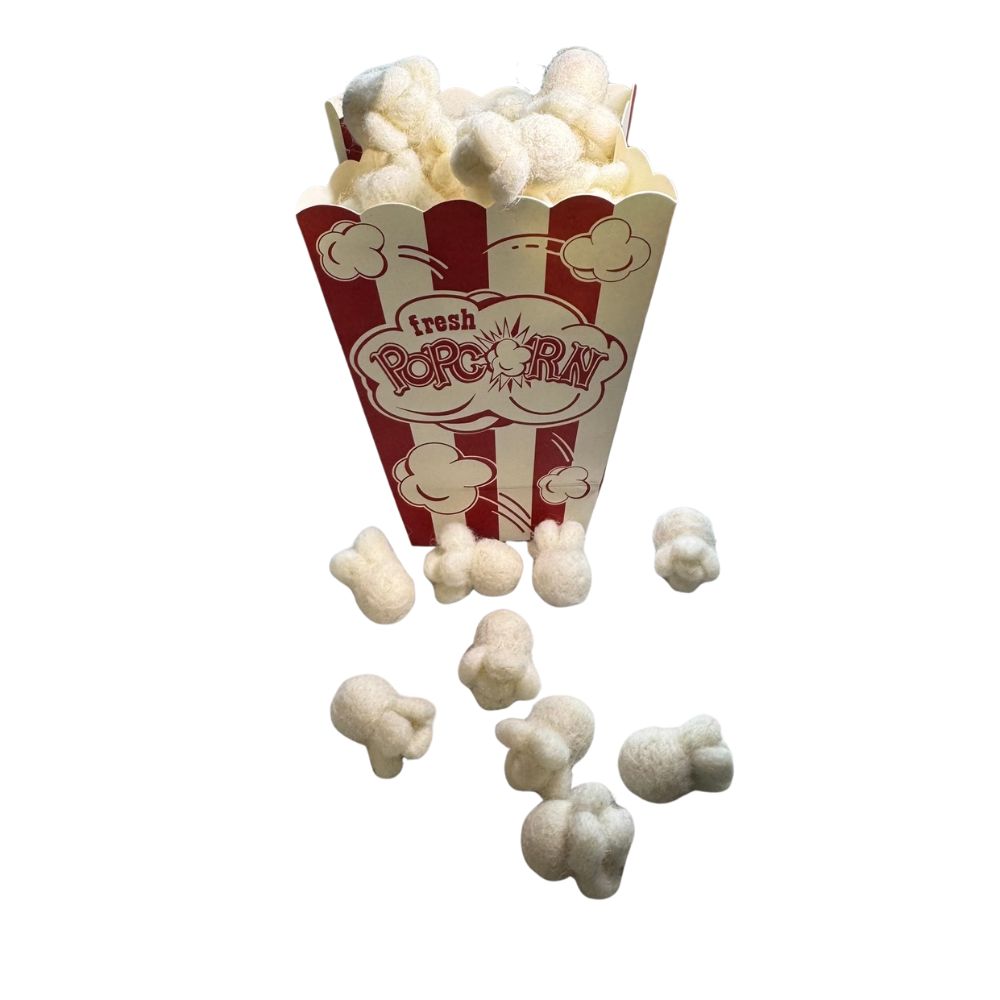 Popcorn-themed cat toy with individual popcorn pieces spilling from a classic striped popcorn box, sprayed with catnip and designed for interactive, durable play