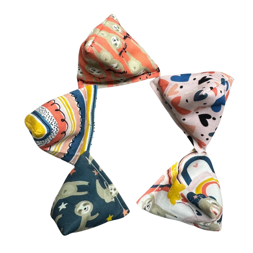 Handmade Sloth Happy Sack cat toys arranged in a circular layout showing multiple fabric prints, pyramid shapes designed for interactive kitten play and filled with signature premium catnip. Made by CatnipTakeout.