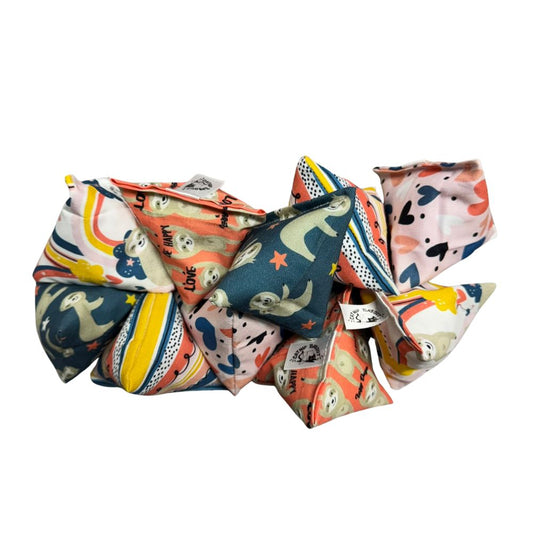 Group photo of handmade Sloth Happy Sack cat toys in mixed prints including stripes, hearts, rainbows, and sloths, pyramid-shaped toys filled with signature premium catnip. Made by CatnipTakeout.