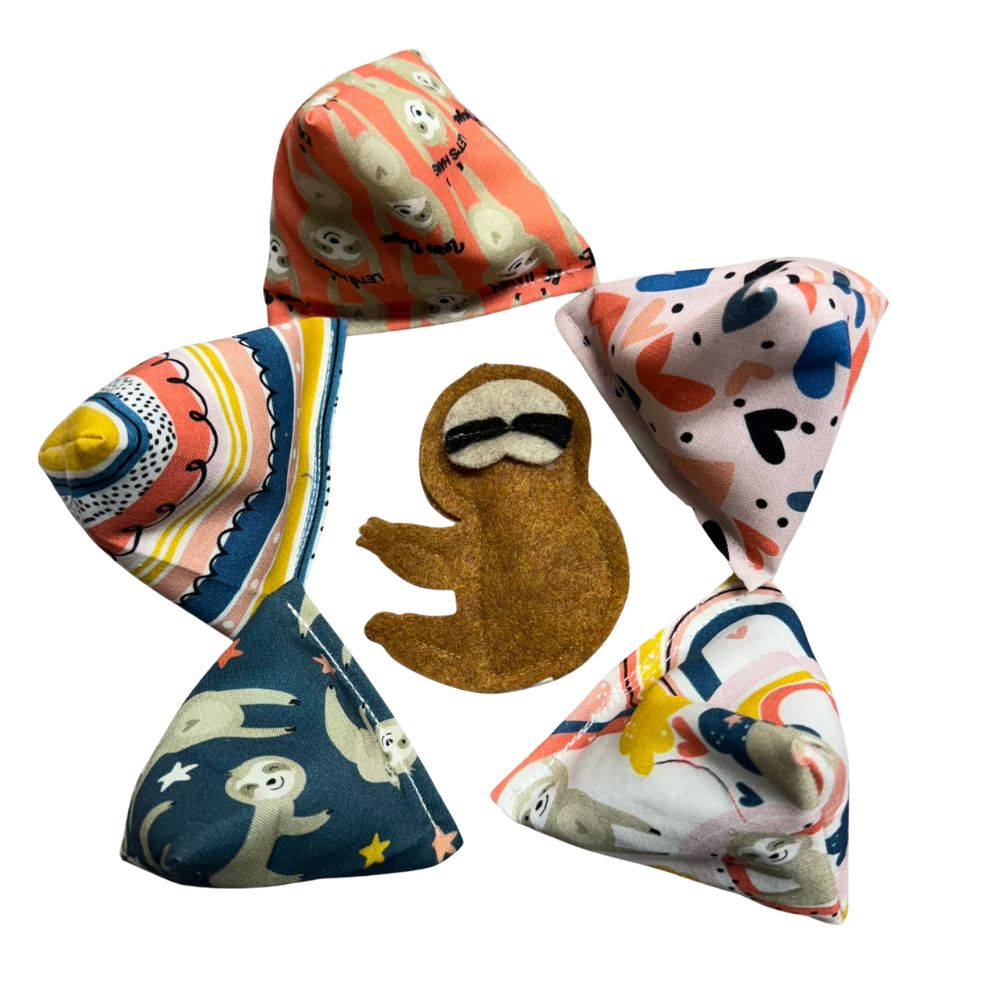 Multi-angle view of handmade Sloth Happy Sack cat toys in assorted prints, pyramid-shaped toys designed for interactive kitten play and filled with signature premium catnip. Made by CatnipTakeout.